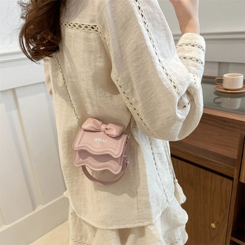A women's mini crossbody bag in PU leather with an adjustable strap, shown in multiple colour options.