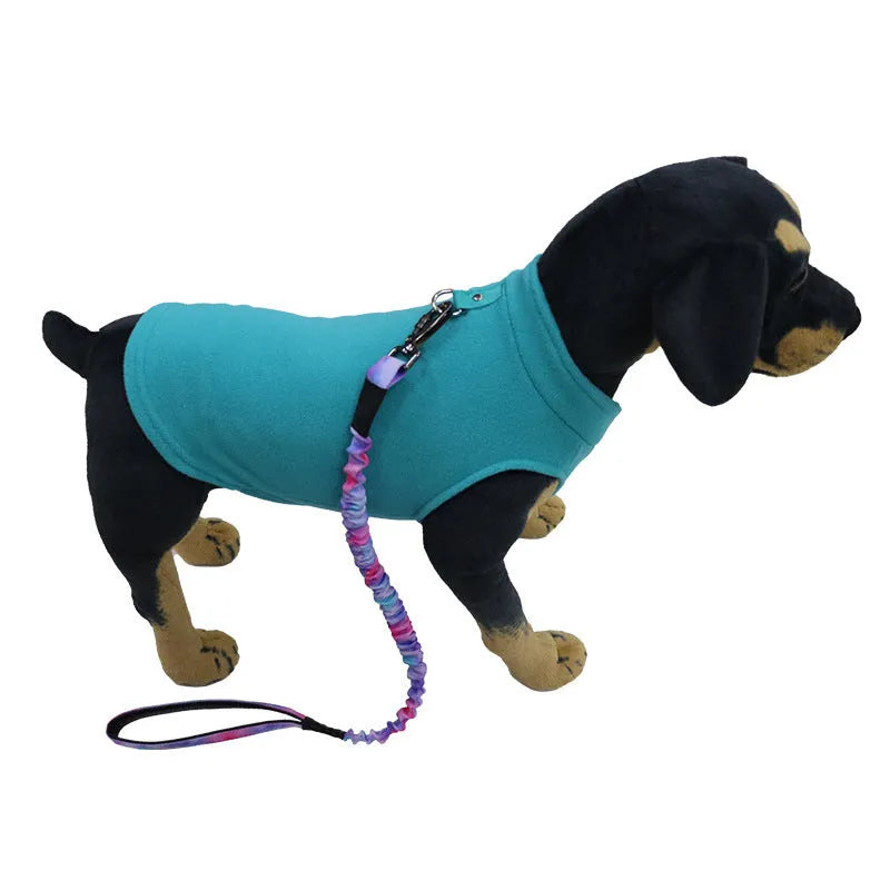 A dog wearing a solid red polar fleece waistcoat, showing the vest-style design for warmth.