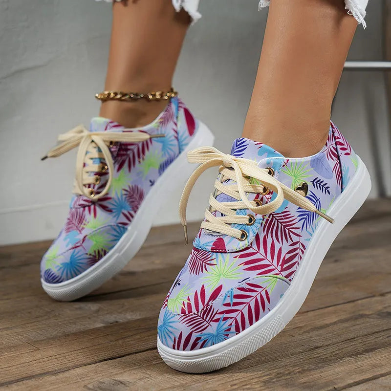 Light blue women's canvas lace-up flats with graffiti leaf print and round toe