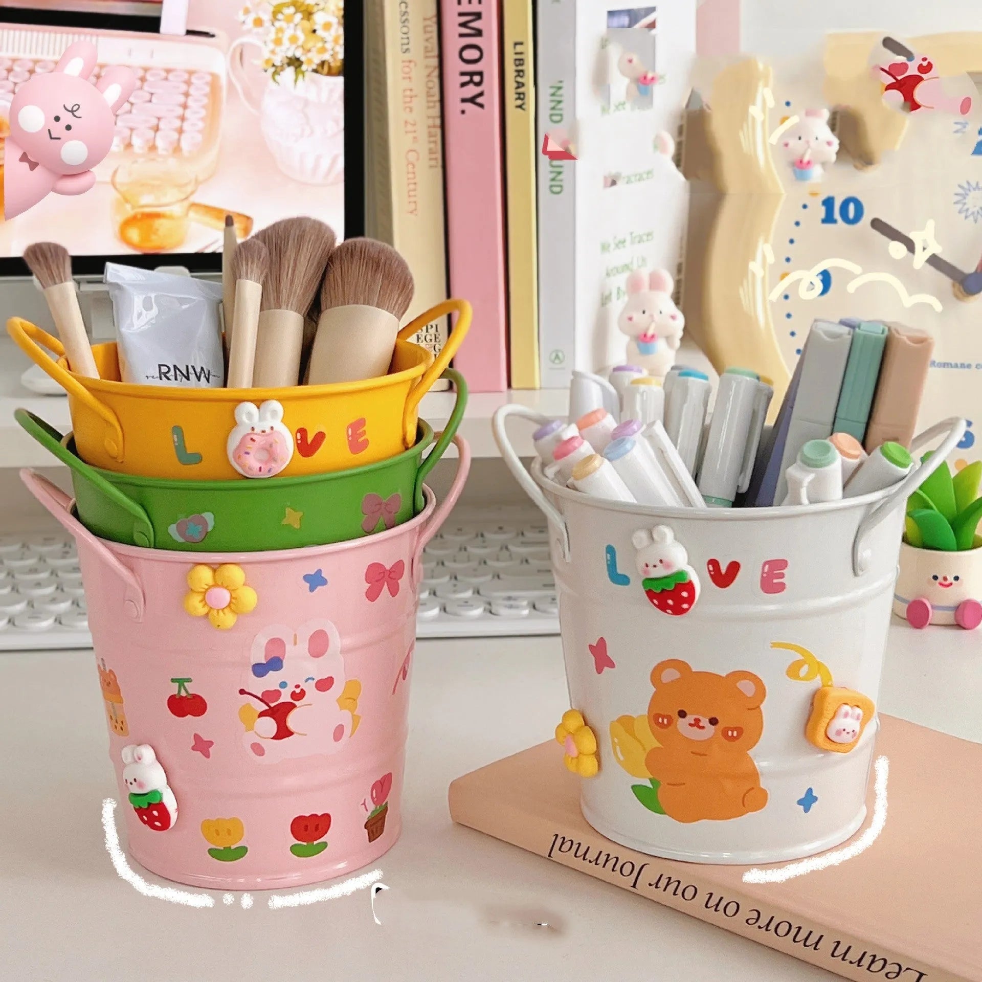 Round metal pen holder in pink with creative iron art design on a wooden desk.