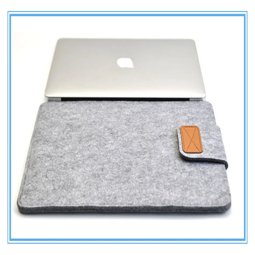 Dark gray felt laptop bag open showing plush lining and tablet compartment