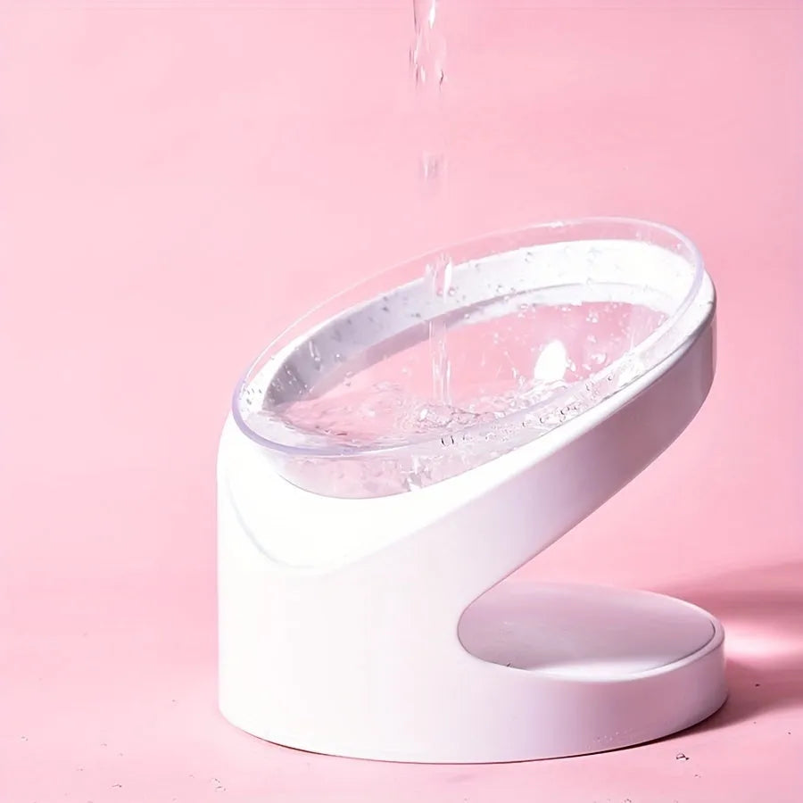 White elevated clear plastic cat food bowl with a tilted feeding surface for neck support.