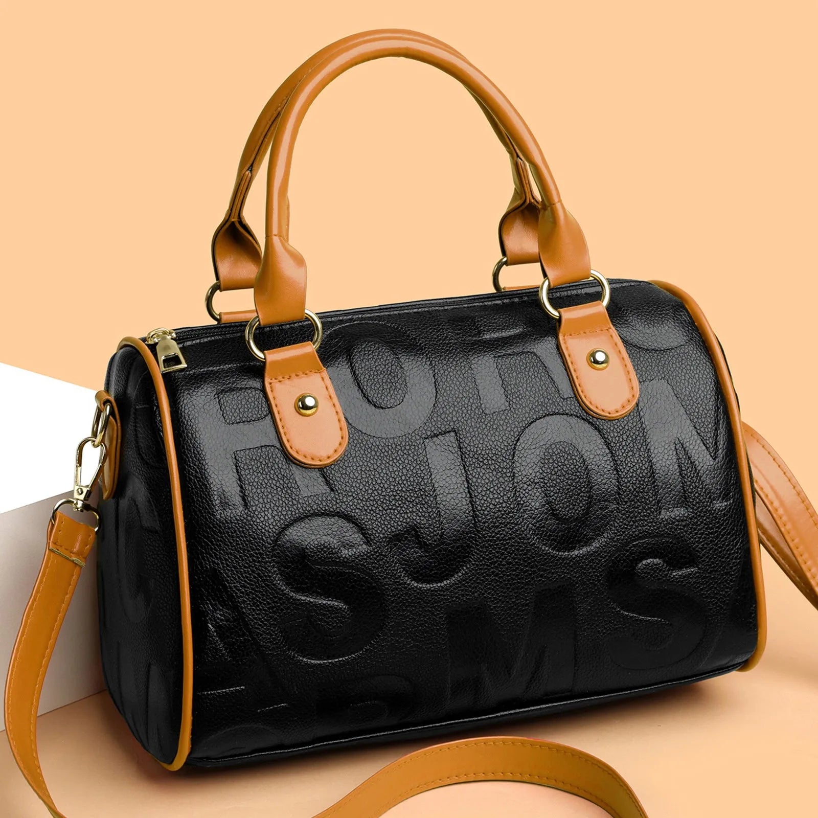 Brown cylindrical crossbody bag with three shoulder straps showing authentic leather texture