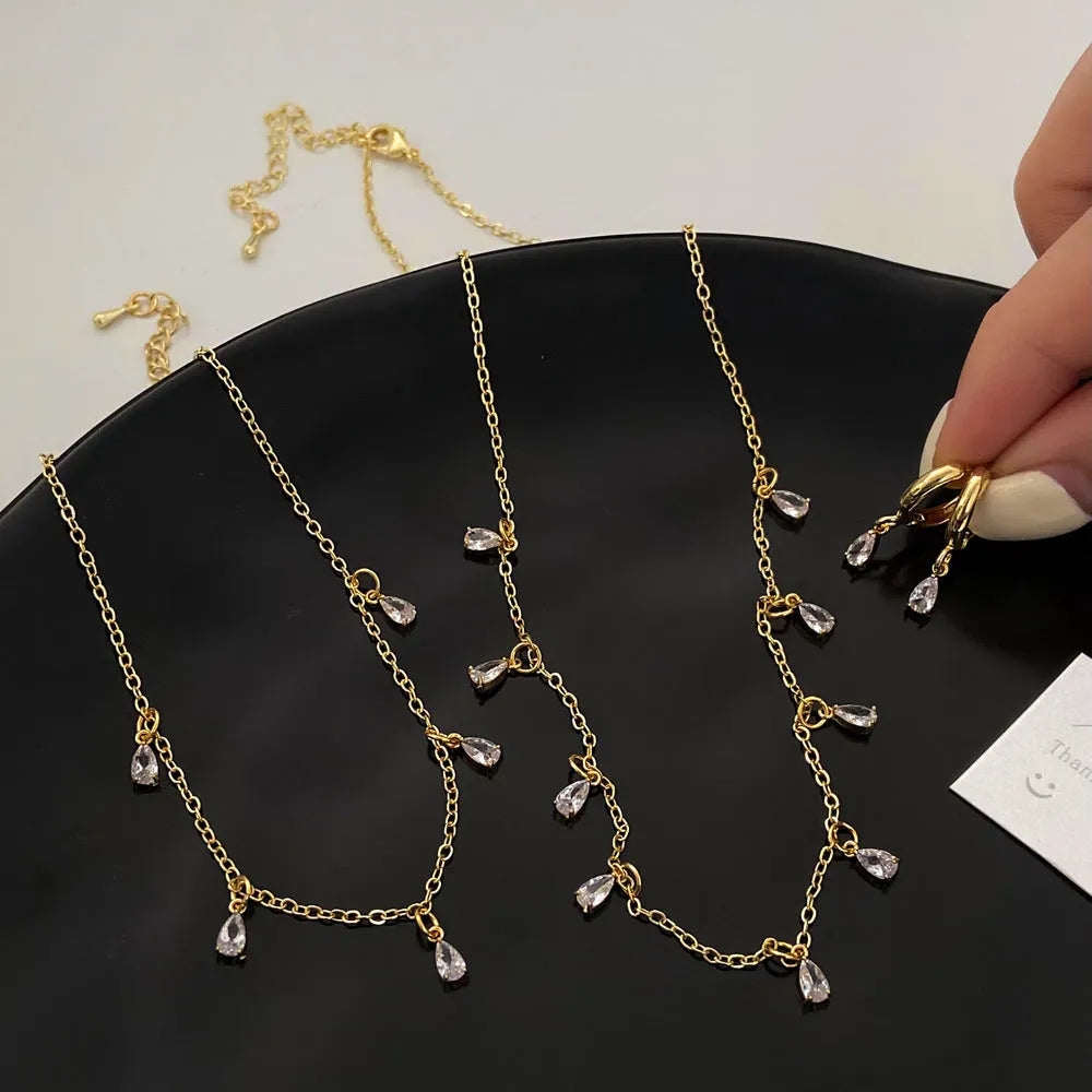 Women's zircon necklace, earrings, and anklet set with geometric pendant and meteor shower design.