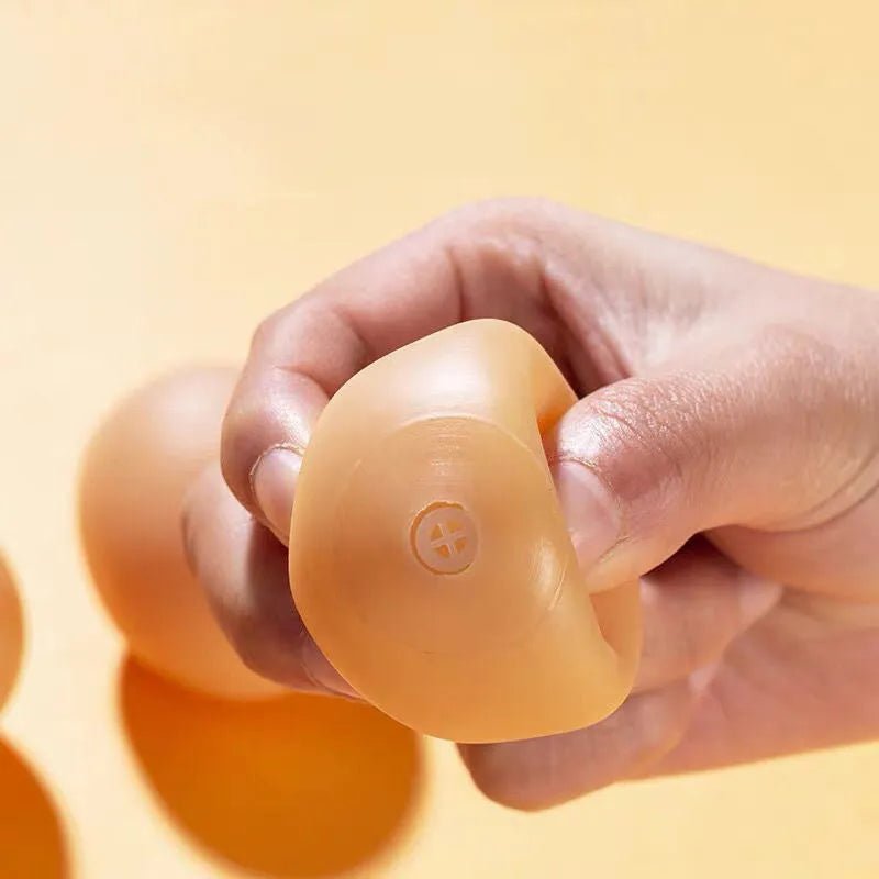 Realistic egg-shaped dog chew toy with textured surface and sound-emitting features for interactive pet play