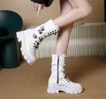 Black women's mid-calf knight boots with metal buckle detail and side zip on a white background