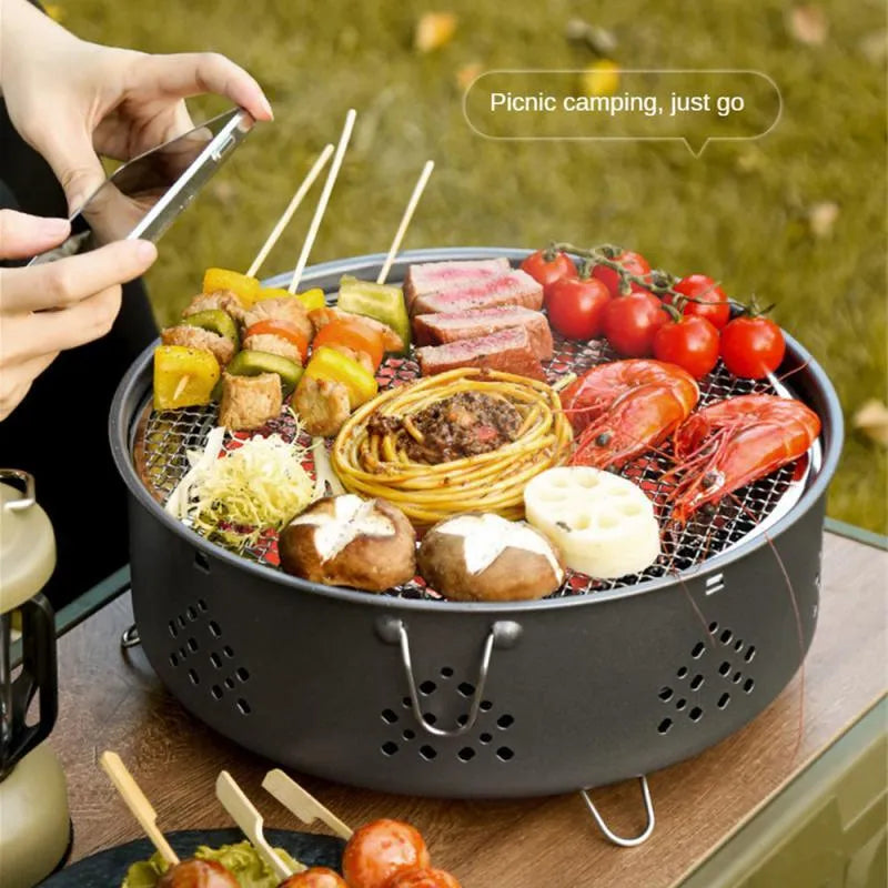 Portable stainless steel detachable BBQ grill with carry bag for outdoor camping.