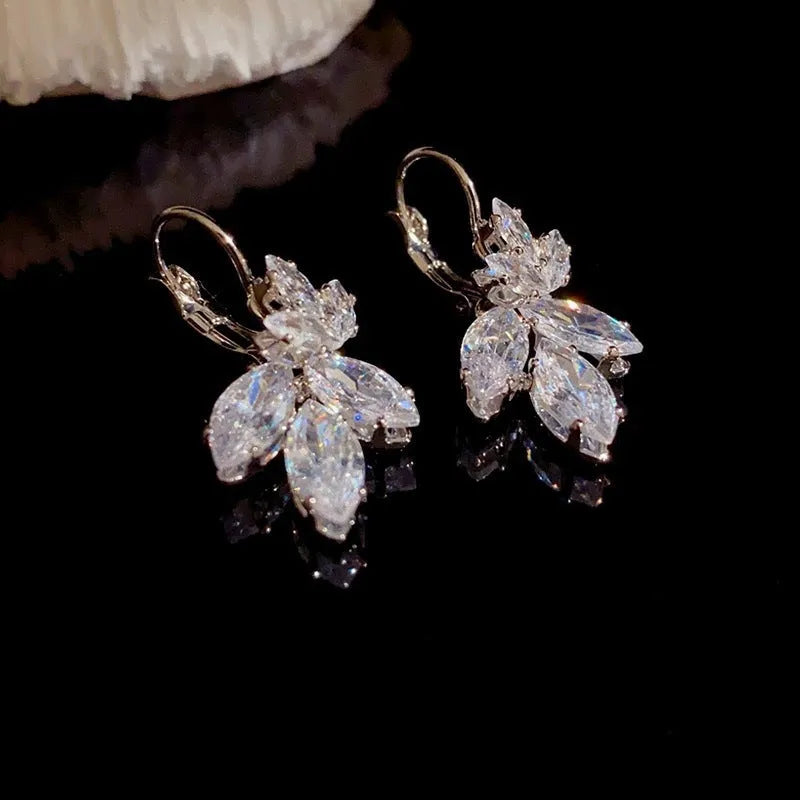 Platinum colour leaf-shaped earrings with inlaid zircon stones