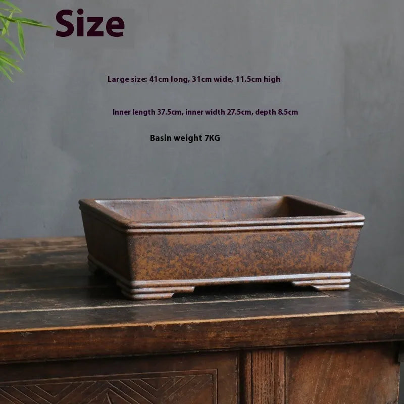 Rectangular unglazed purple sand bonsai pot showing simple design and base with five drainage lines.