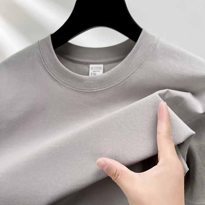Men's solid colour cotton t-shirt with drop shoulder design on a hanger.
