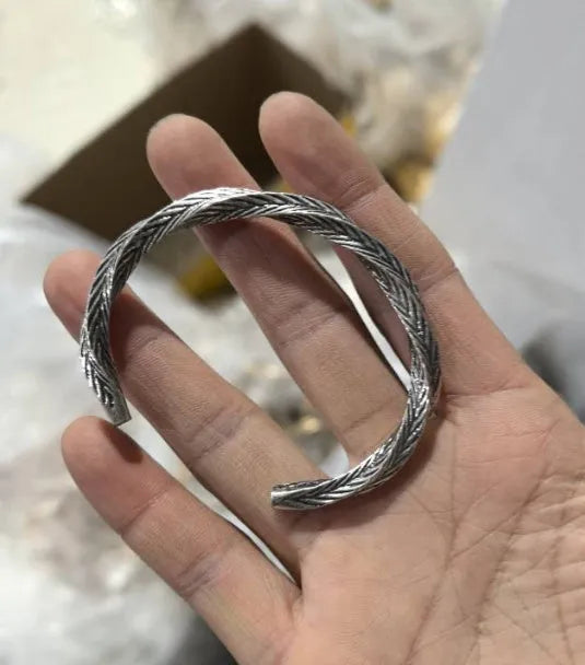 Men's white titanium steel pattern bracelet with geometric design on plain background