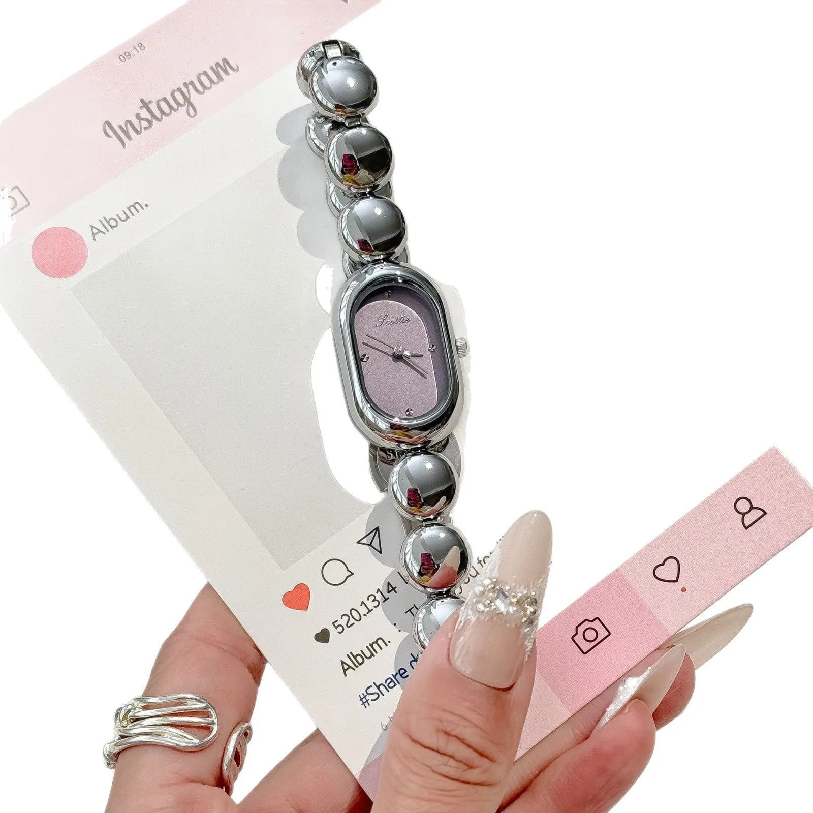 Oval women's fashion watch on wrist showing 9mm thick case, available in black gold, platinum and other colours.