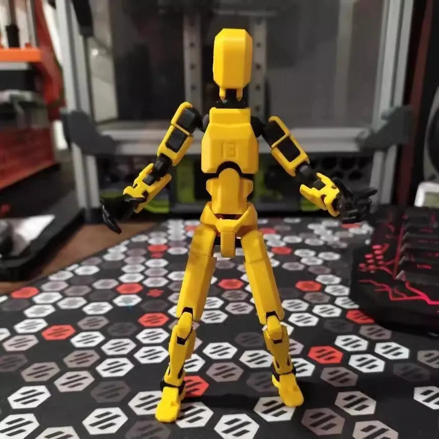 3D printed multi-jointed robot action figure model with movable joints on a desk.