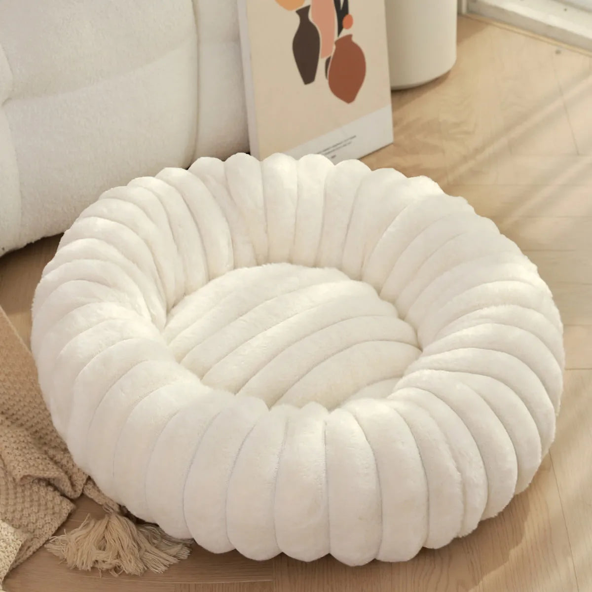 Round plush pet bed with long-hair rabbit fur style texture in beige colour
