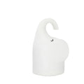 DOMI Elephant shaped silicone night light with warm white glow on a bedside table.