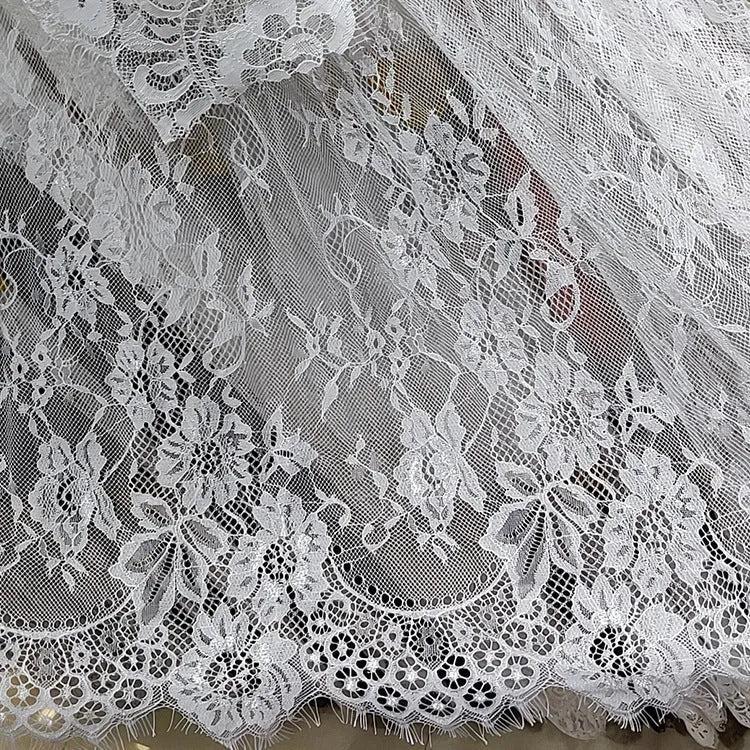 White embroidered lace tablecloth made from nylon yarn, 150x300cm, laid flat on a table with decorative pattern visible.