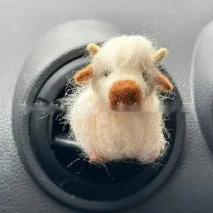 Scottish Highland Niutong air outlet clip in white plastic on a car dashboard vent