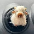 Scottish Highland Niutong air outlet clip in white plastic on a car dashboard vent