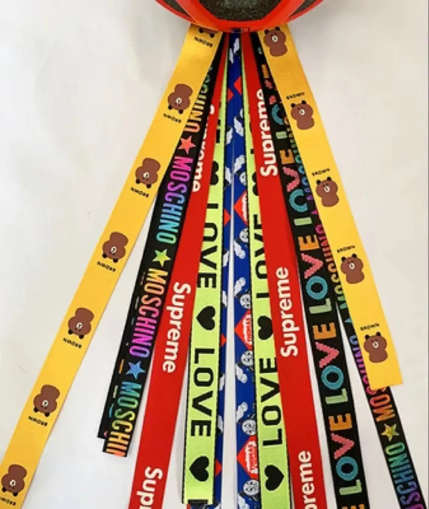 A decorative ribbon streamer for attaching to a child's roller skate or ski helmet, shown in a selection of colours.