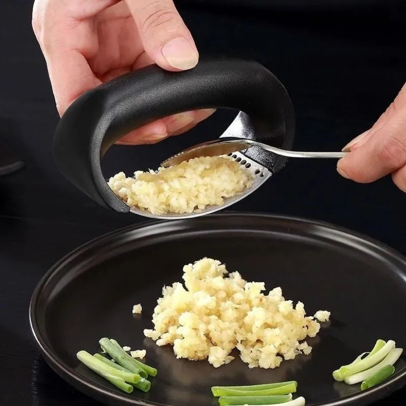 Stainless steel manual garlic press with ergonomic handle in assorted colours