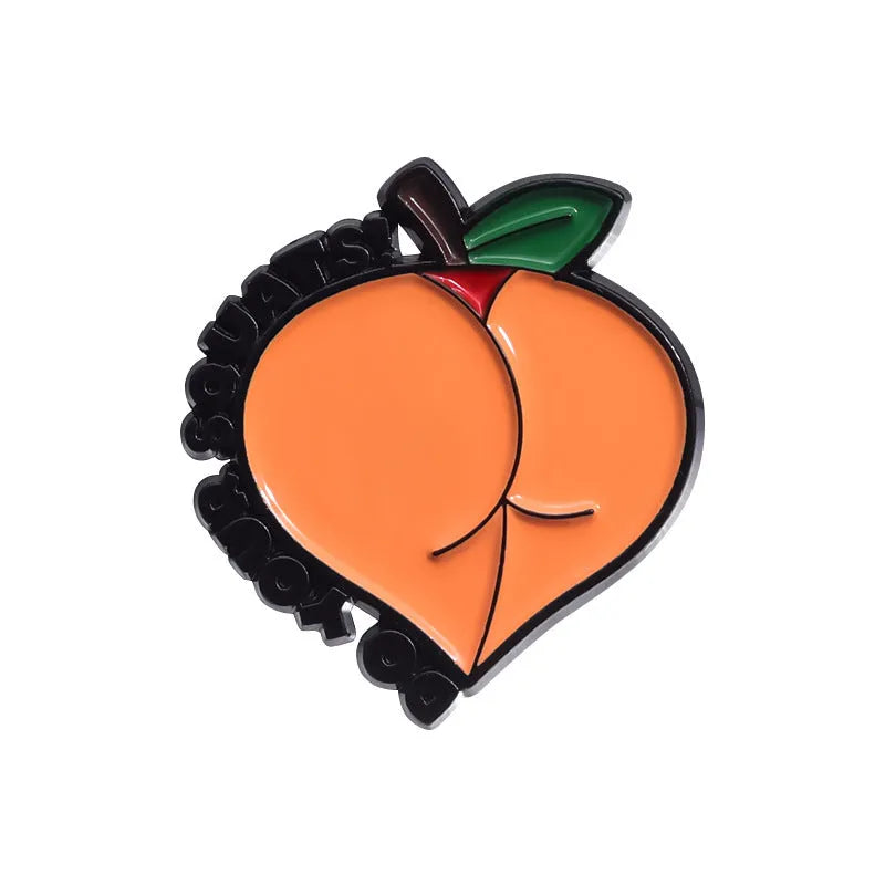 Colourful cartoon-style fruit metal brooch with pin back on a denim jacket lapel.