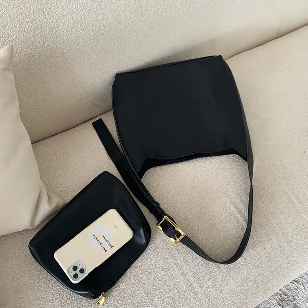 Women's soft PU shoulder bag with tassel detail in black and brown colour options