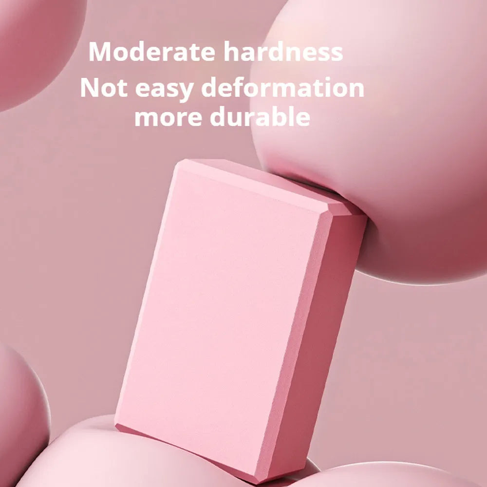 Solid blue EVA foam yoga brick with ridged hexagonal surface, shown next to a pink block.