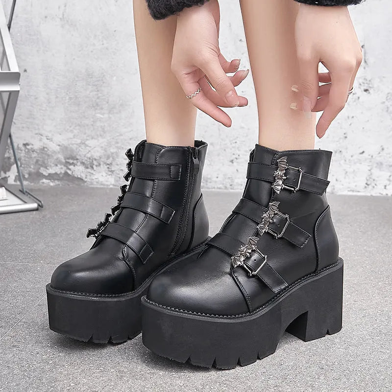 Black women's punk platform ankle boots with bat buckle and side zip.
