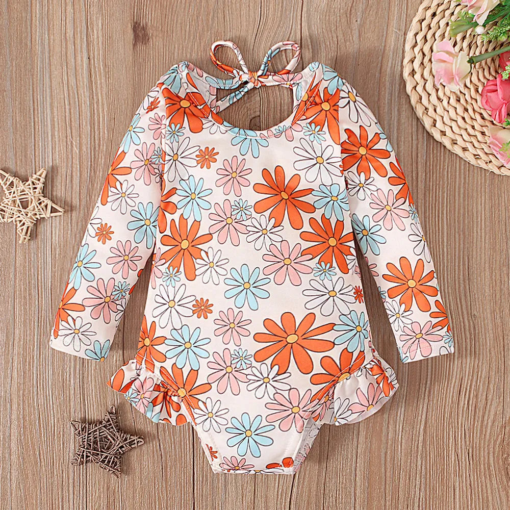 Girl's white floral print one-piece swimsuit with crew neck and open back design