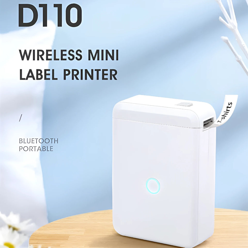 White D110 compact thermal label printer on desk with label paper and USB cable