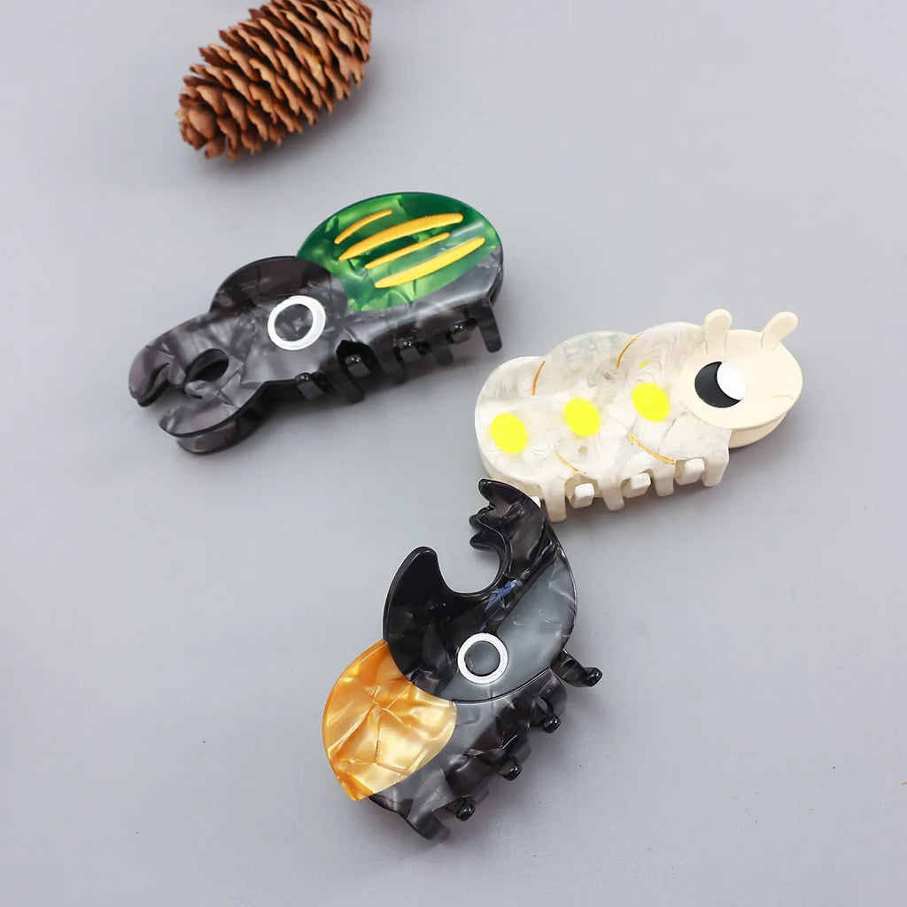 Handmade cellulose acetate beetle grip hair accessory with cartoon insect design