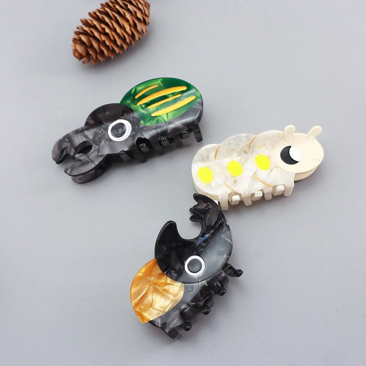 Handmade cellulose acetate beetle grip hair accessory with cartoon insect design