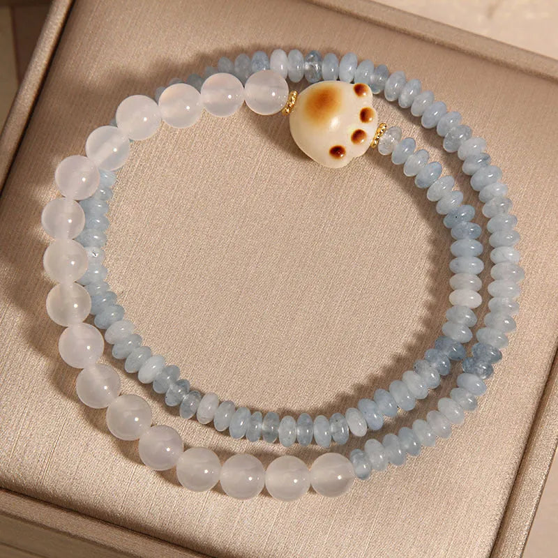 Women's crystal bracelet with aquamarine abacus beads, white agate, and cat's paw accents in double ring design