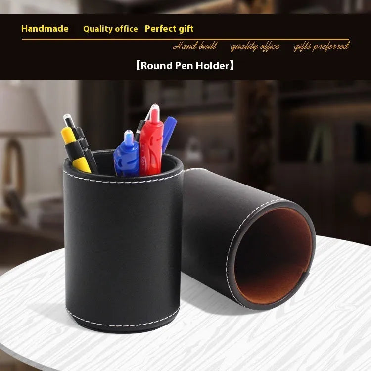 Small round black leather pen container for desk organisation.