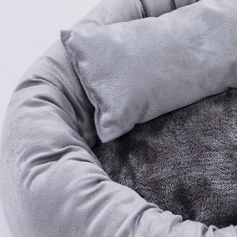 Grey round plush pet bed with a raised rim and non-slip base for small dogs and cats.