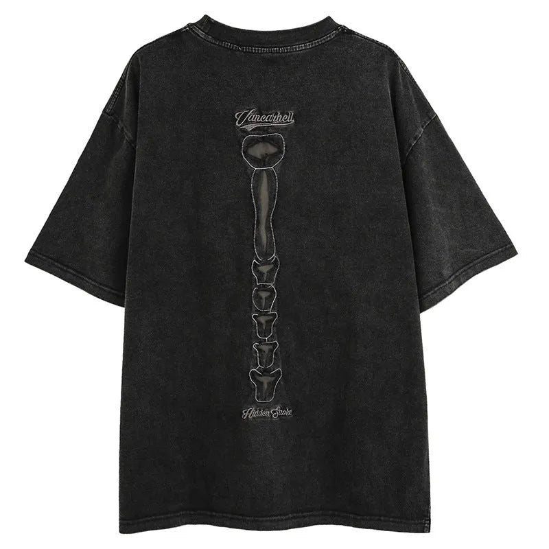 Man's loose brown t-shirt with a large black skull and letter graphic print on the front, featuring drop-shoulder sleeves.