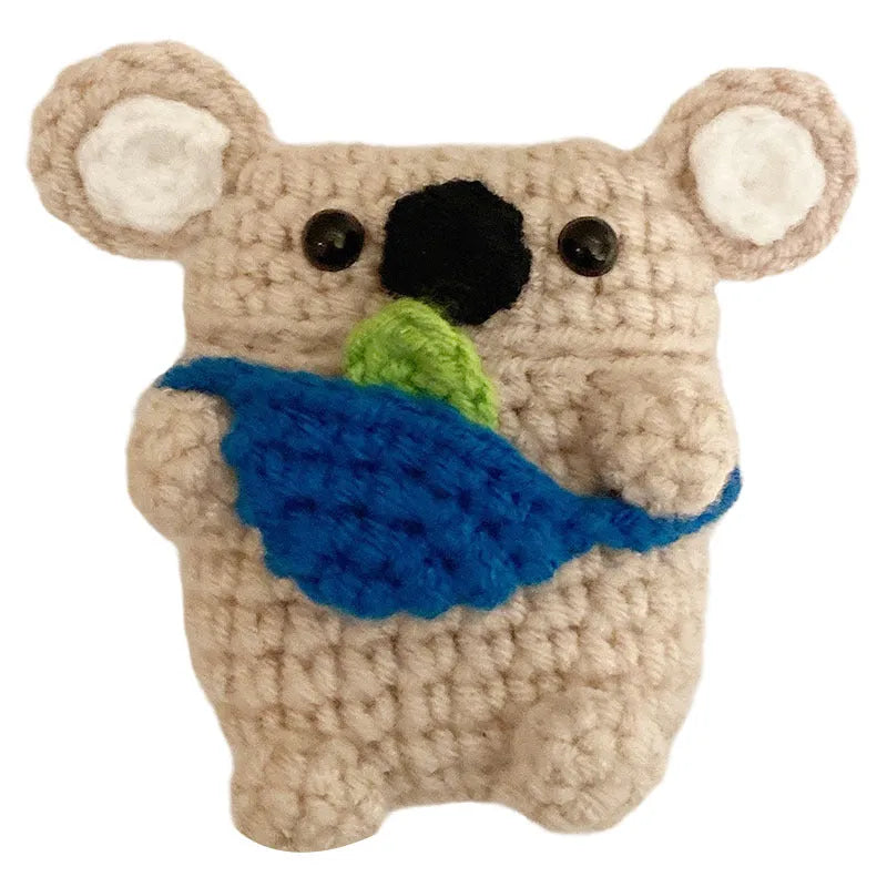Hand-knitted grey koala bear design cover on a white Airpods case.