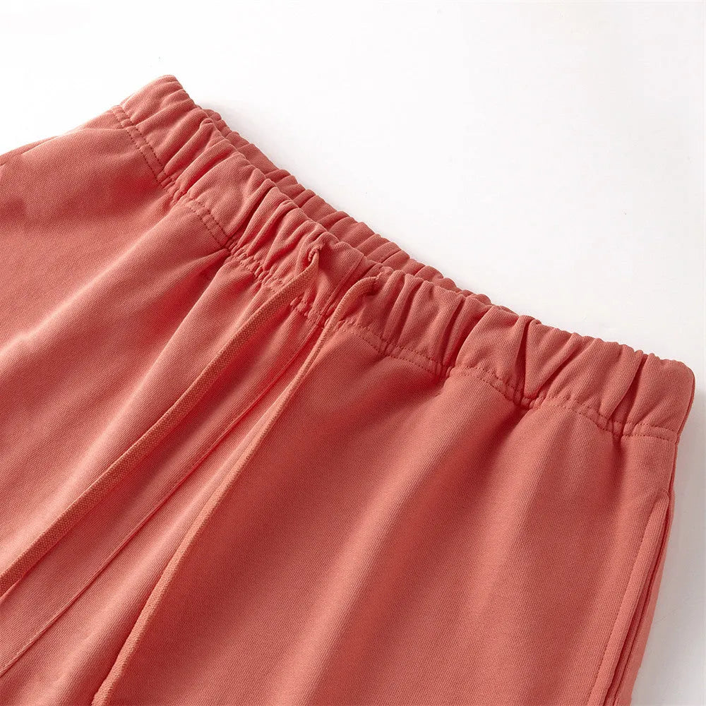 Men's cotton loose fit solid colour shorts in assorted colours like black, navy, and grey
