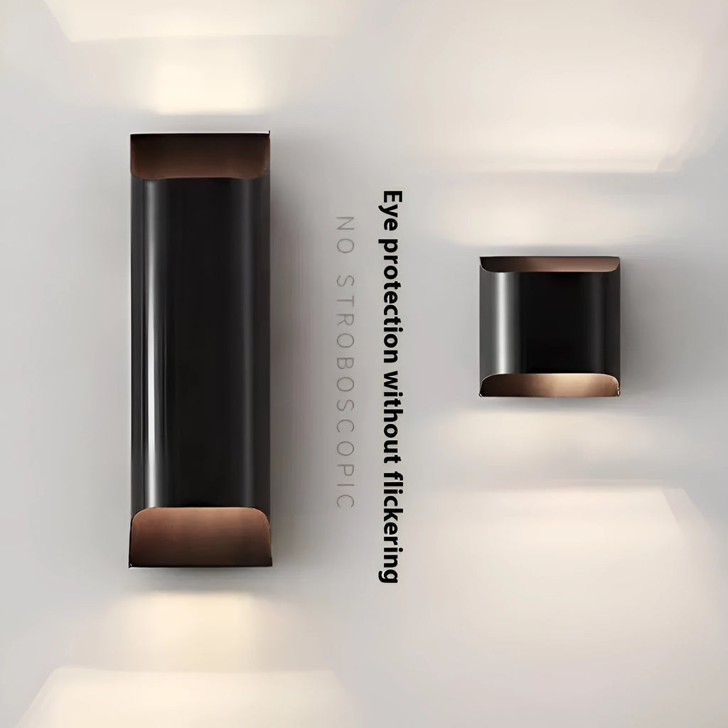 Minimalist copper wall lamp with black gold finish mounted beside bed