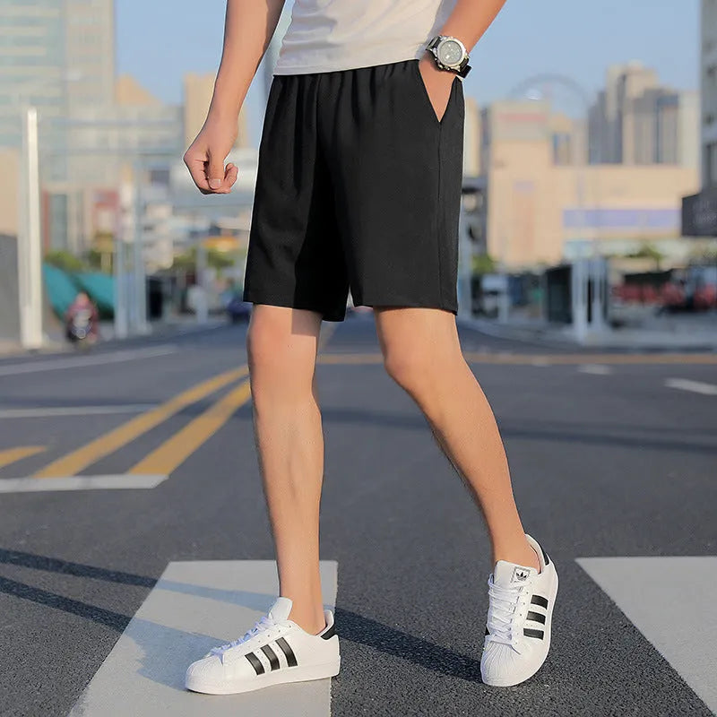 Men's grey cotton quick-drying five-point sports shorts with elastic waistband, front view