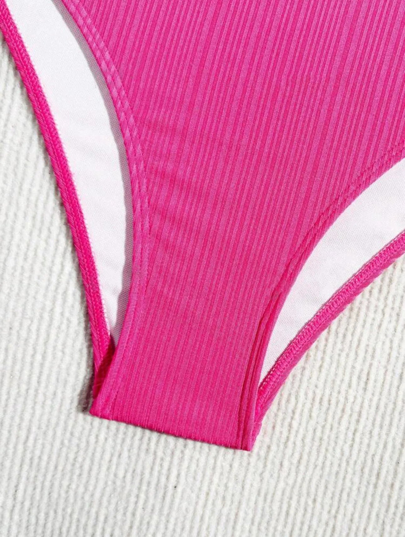 Black and pink women's lace-up halter bikini set with briefs, made from polyester fabric.