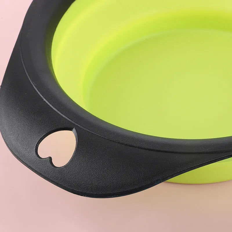 Black silicone pet bowl shown open and folded flat next to a dog leash.