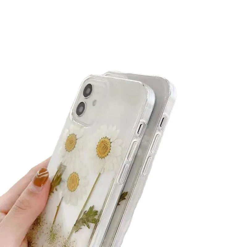 White iPhone case with a raised epoxy daisy floral pattern on the back.
