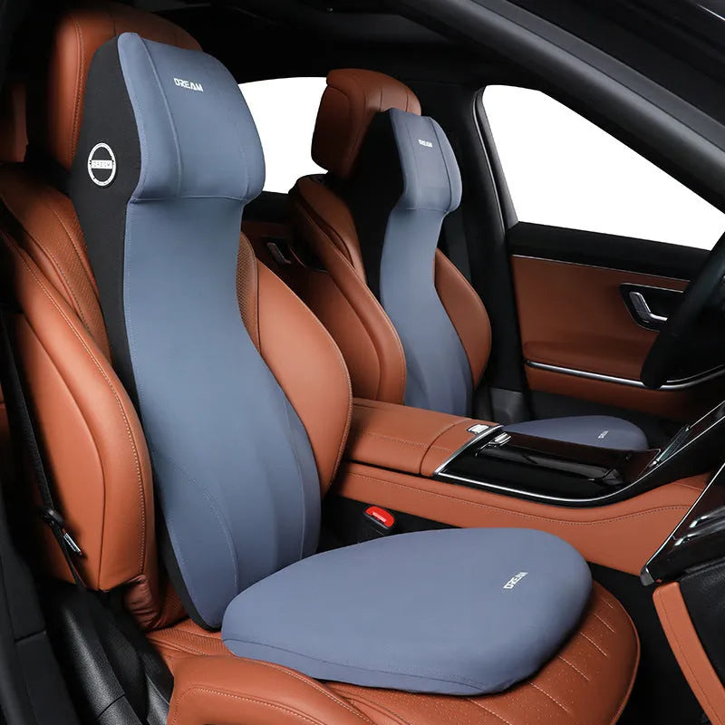 Black automotive memory foam waist cushion and headrest pillow set on a car seat.