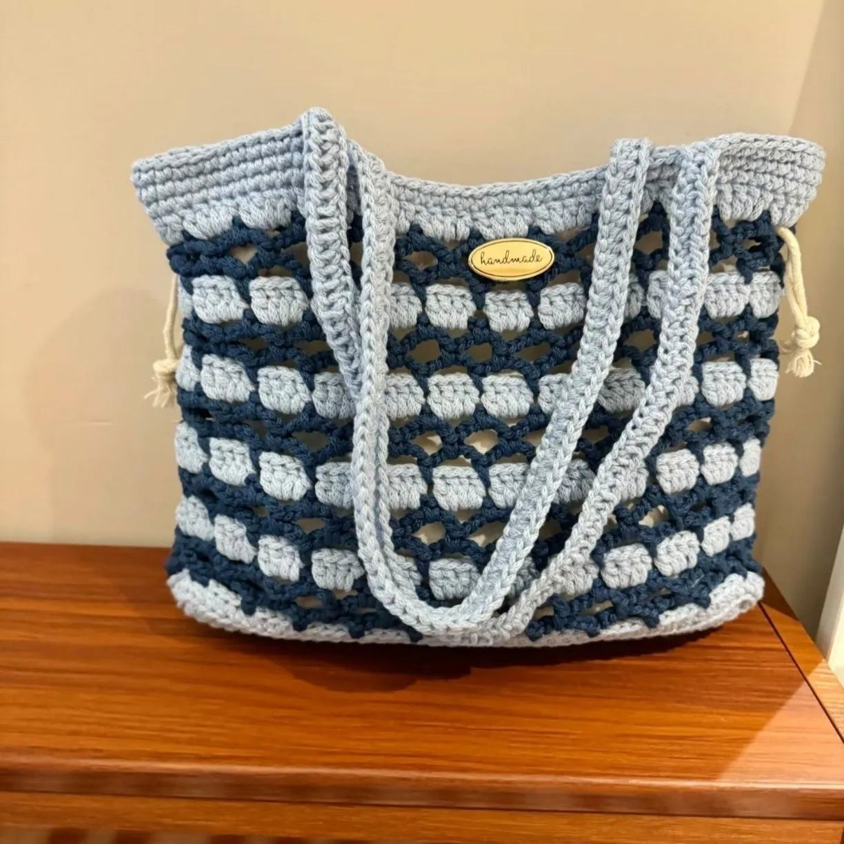 Handwoven wool summer tote bag with a floral patterned design.