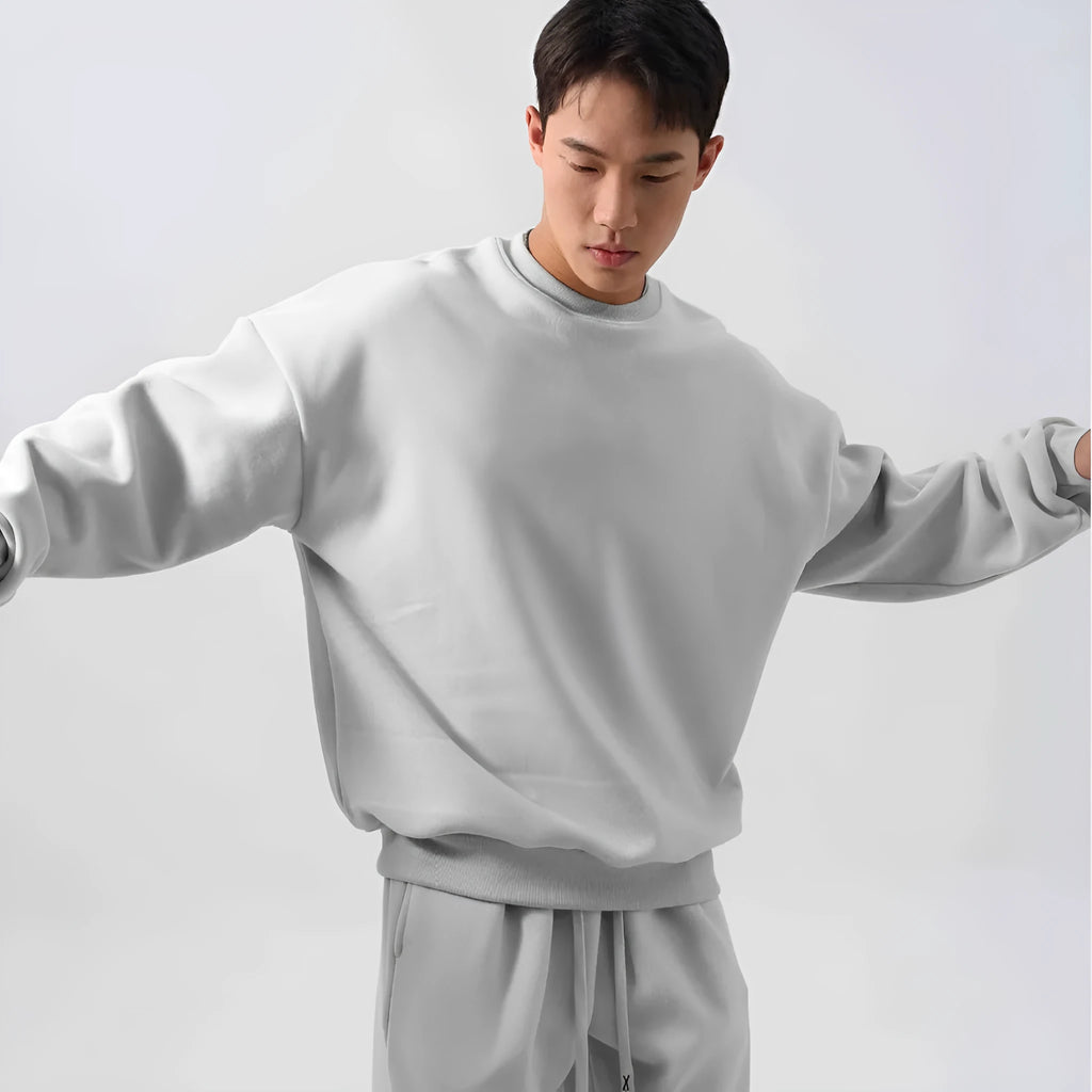 Men's black polar fleece sports suit set with long sleeve coat and loose trousers on a hanger.