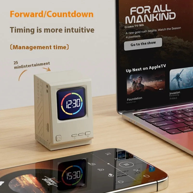 Retro small computer lyrics speaker table clock wireless Bluetooth speaker in pink purple colour on a desk