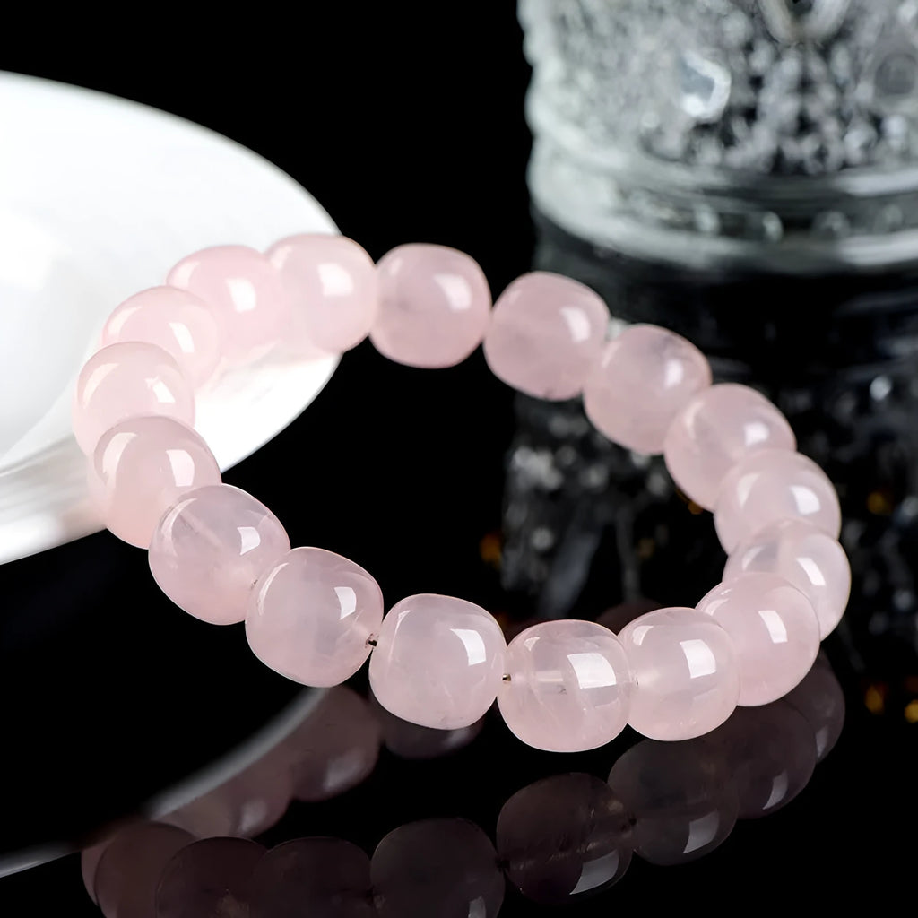Pink natural bamboo crystal bracelet with geometric barrel beads on a wrist.
