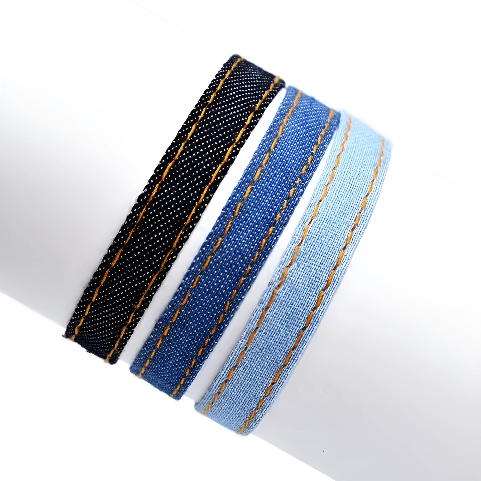 Handmade denim bracelet carrying strap shown in one of eleven available colour options with mixed material construction