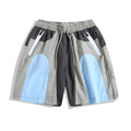 Man wearing blue patchwork loose-fit quick-drying casual sports shorts.